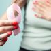 woman with pink ribbon and breast cancer awareness